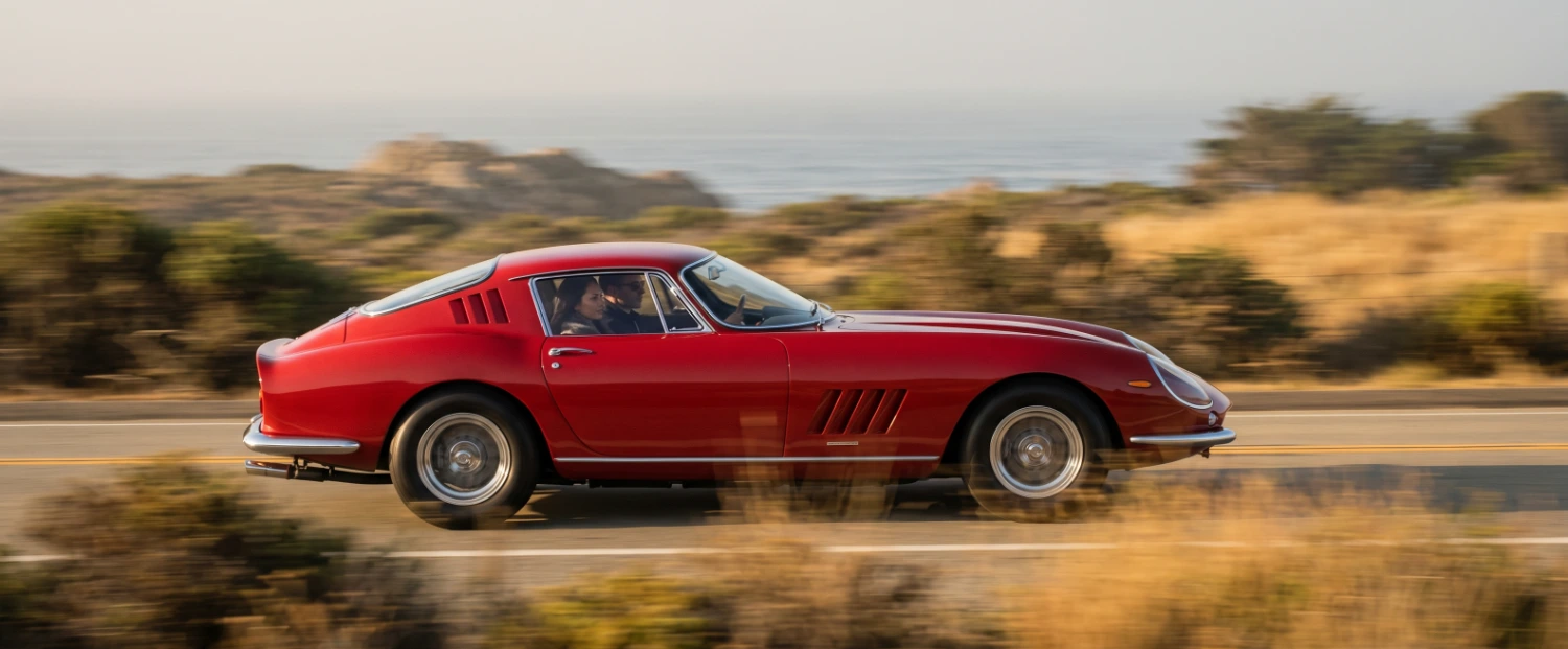 Red sports car on an open road.