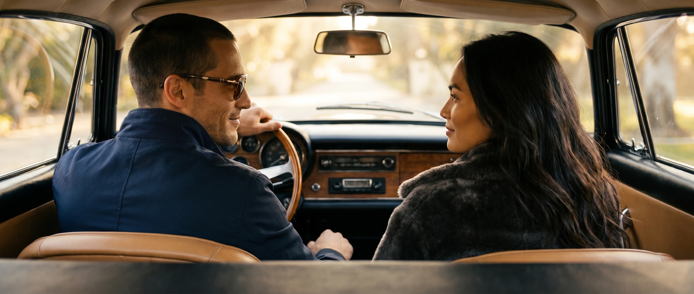 Couple in a convertible, wide campaign crop.