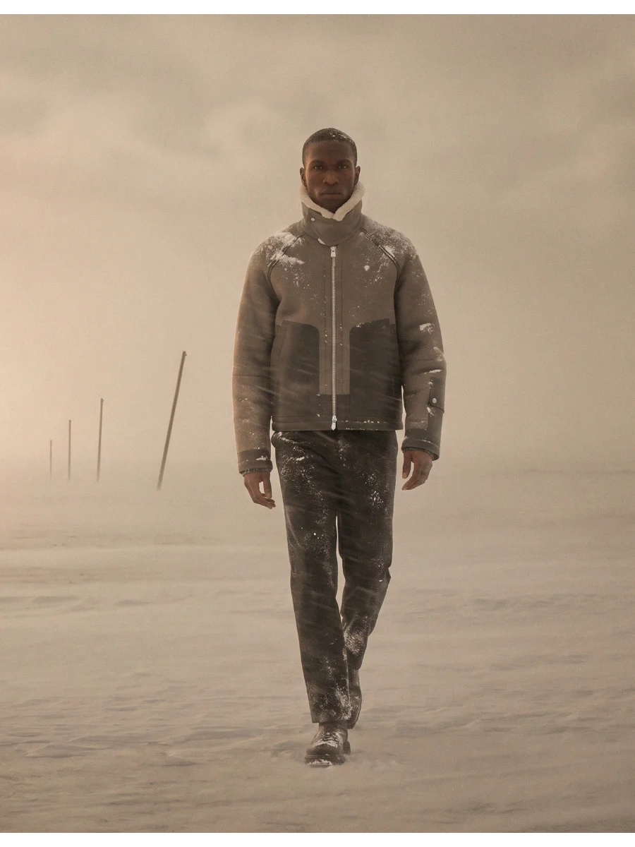 Man walking through snow, still frame.